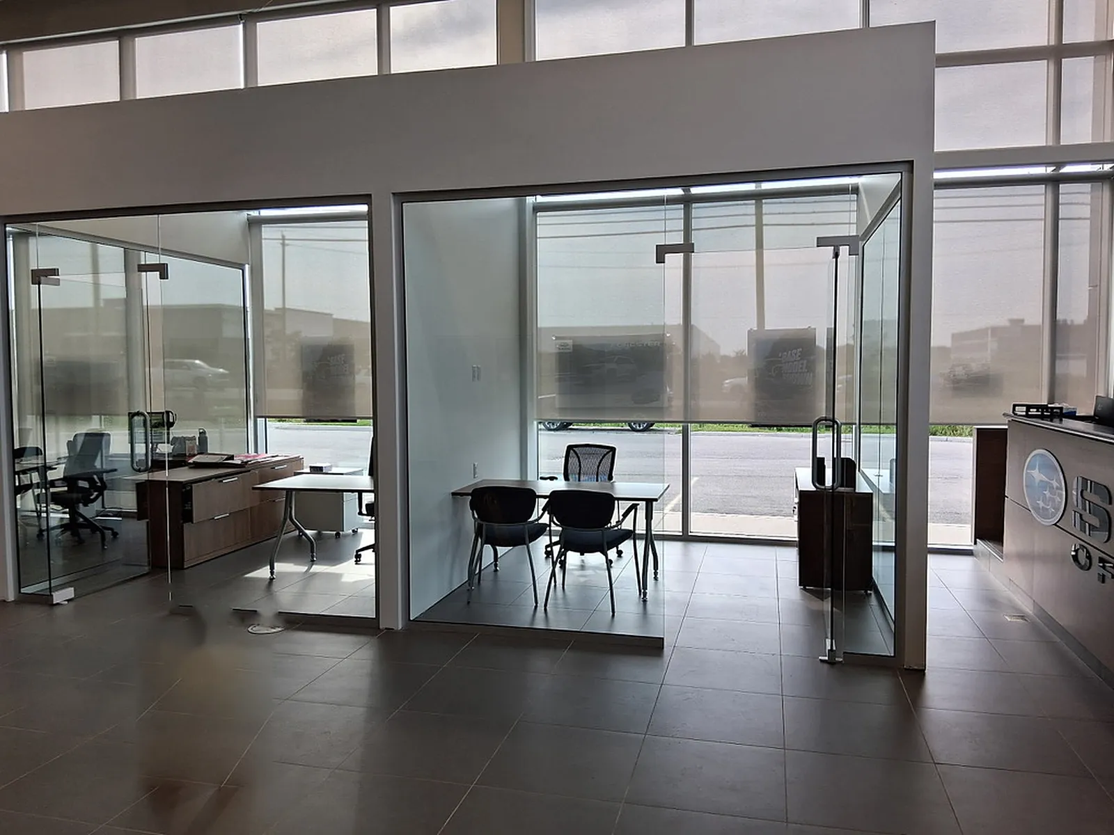 Glass-front offices and a reception counter on a tiled floor