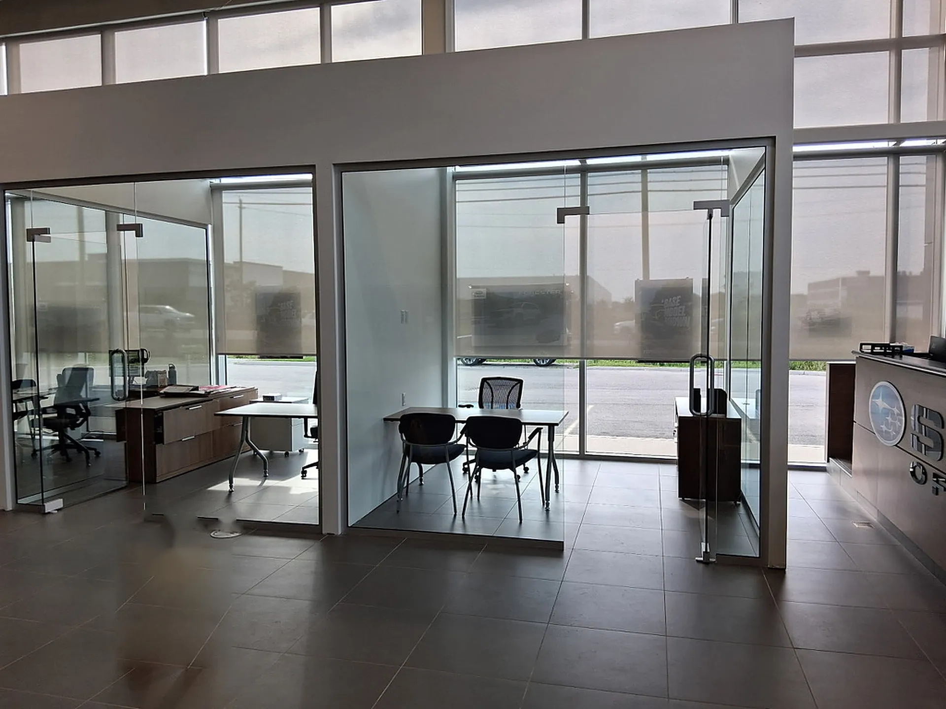 Glass-front offices and a reception counter on a tiled floor