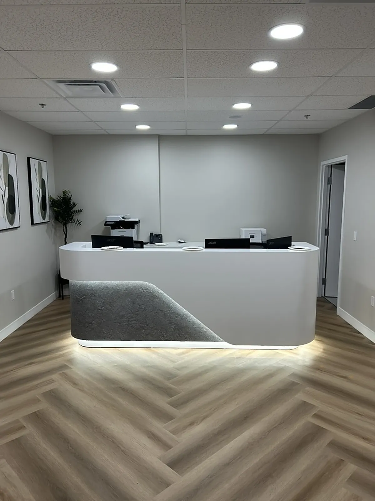 Reception desk with LED underglow on herringbone flooring